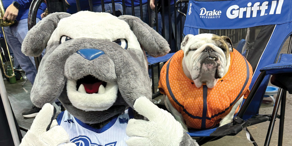 Mascot alongside a bulldog in a basketball outfit.