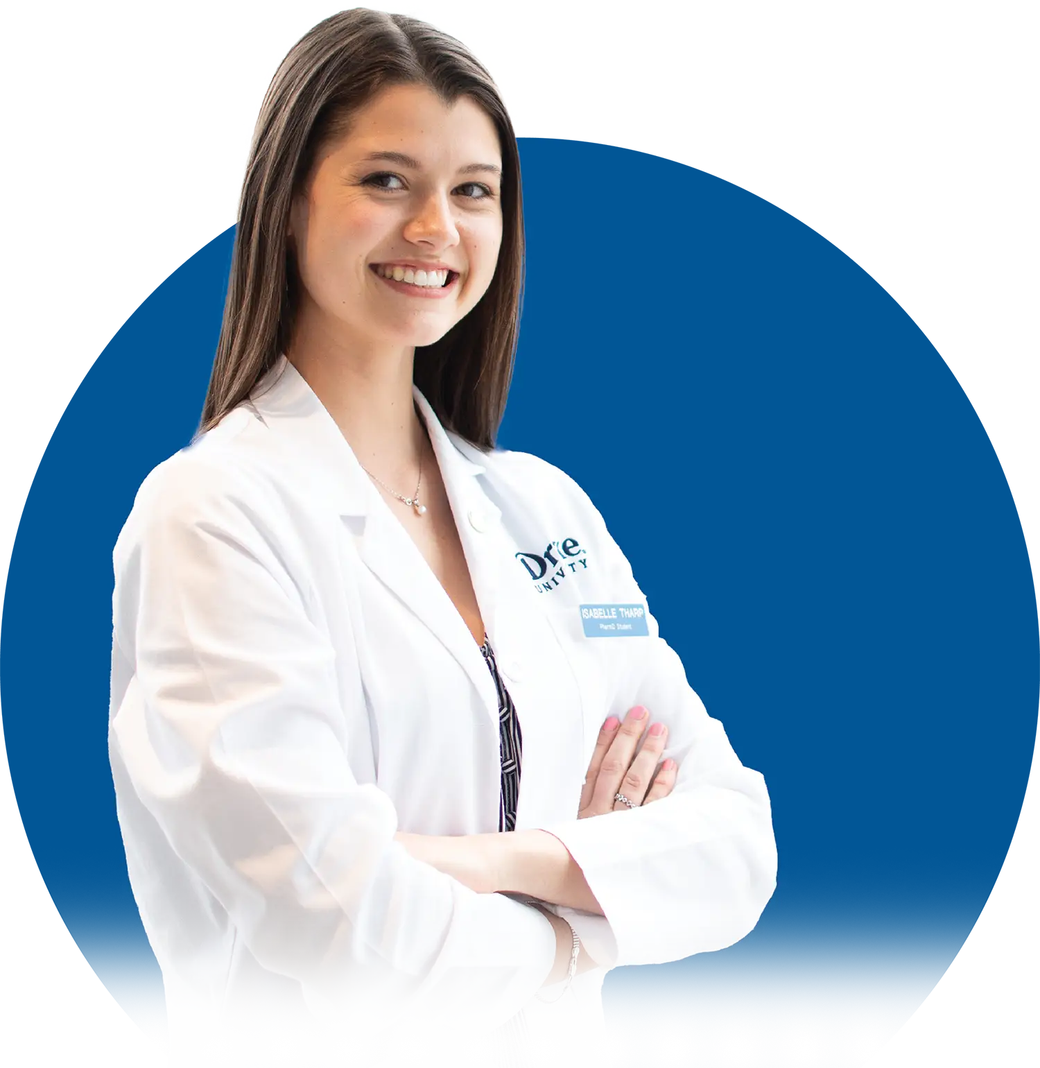 Young woman in a white lab coat smiling with arms crossed.