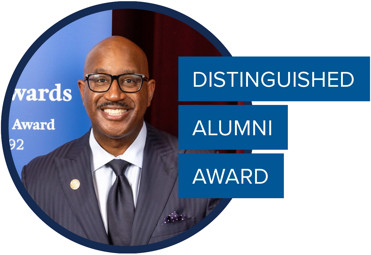 Circular headshot of Cain Hayes; text overlay reads "DISTINGUISHED ALUMNI AWARD."