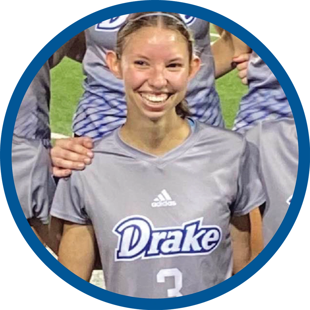Bridgid Miller with her hair pulled back, wearing a gray "Drake" athletic t-shirt with a blue circular border framing the image.