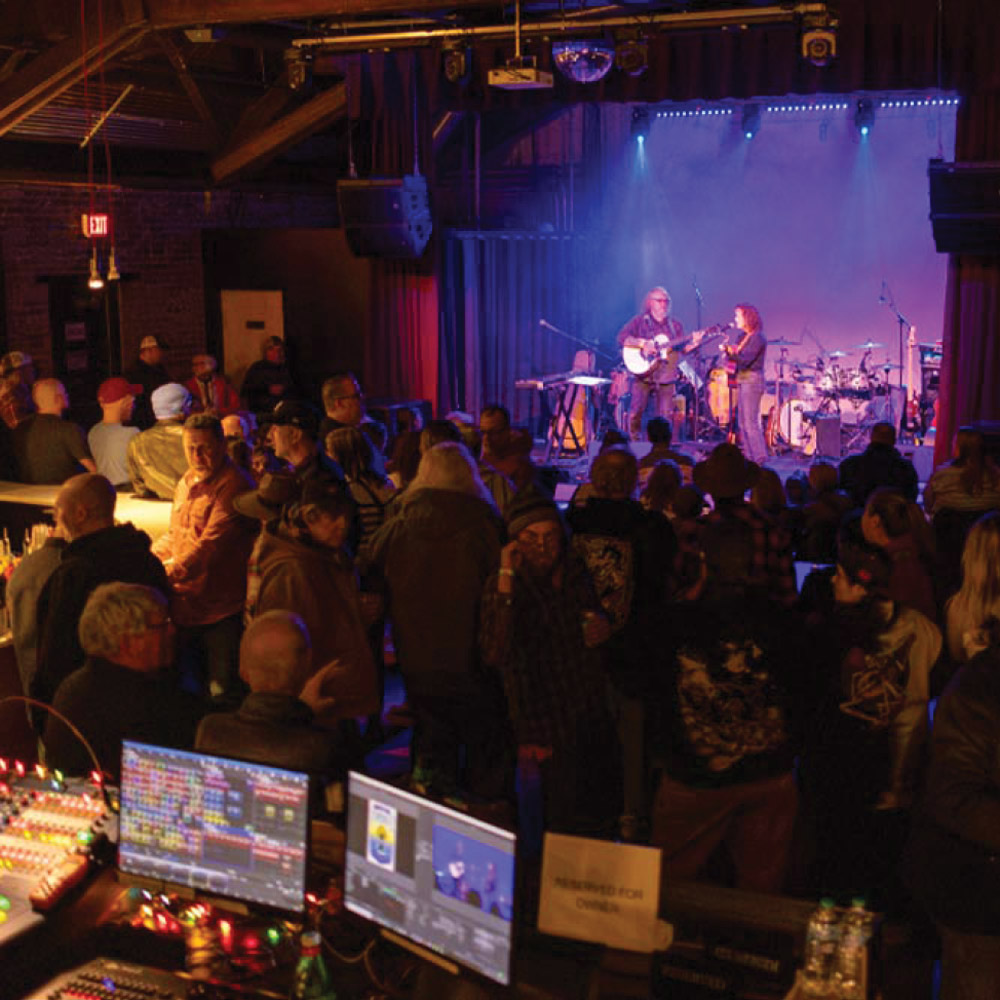 A shot of a live musical performance. This venue is a centerpiece of the local arts scene, known for its intimate atmosphere and professional production.