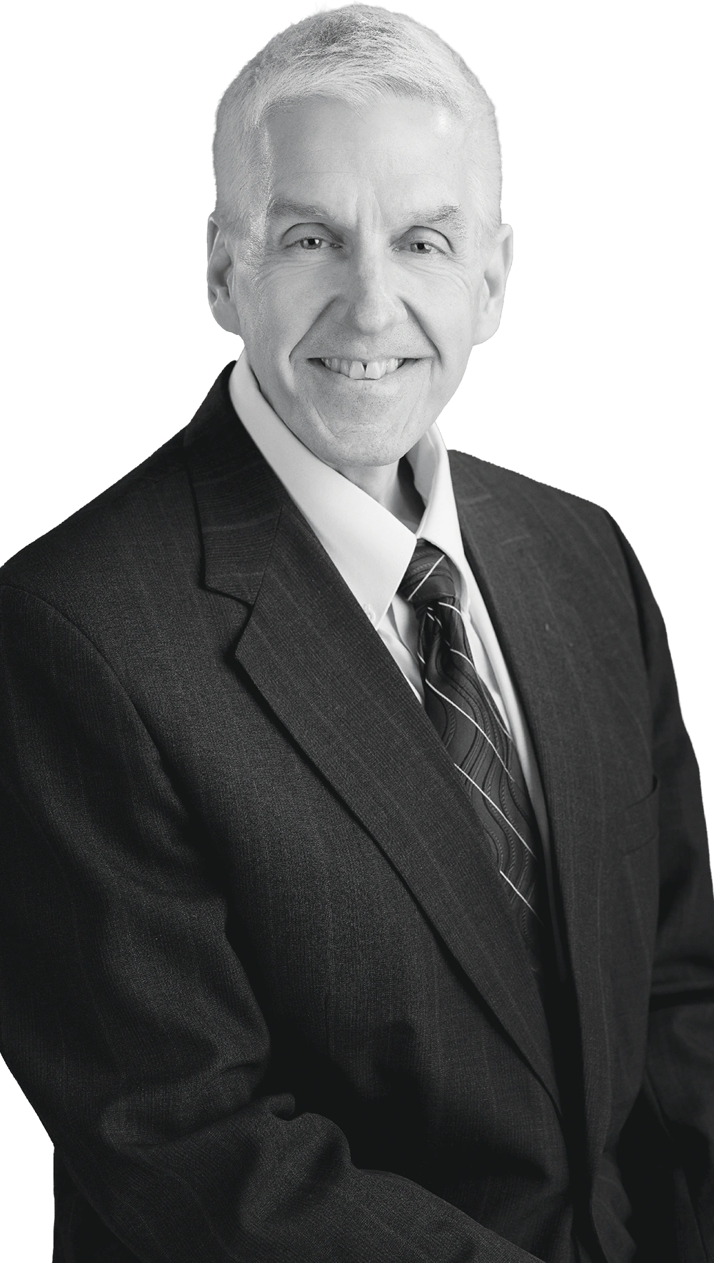 Black-and-white portrait of a smiling Joe Graves with short light hair wearing a suit and striped tie.