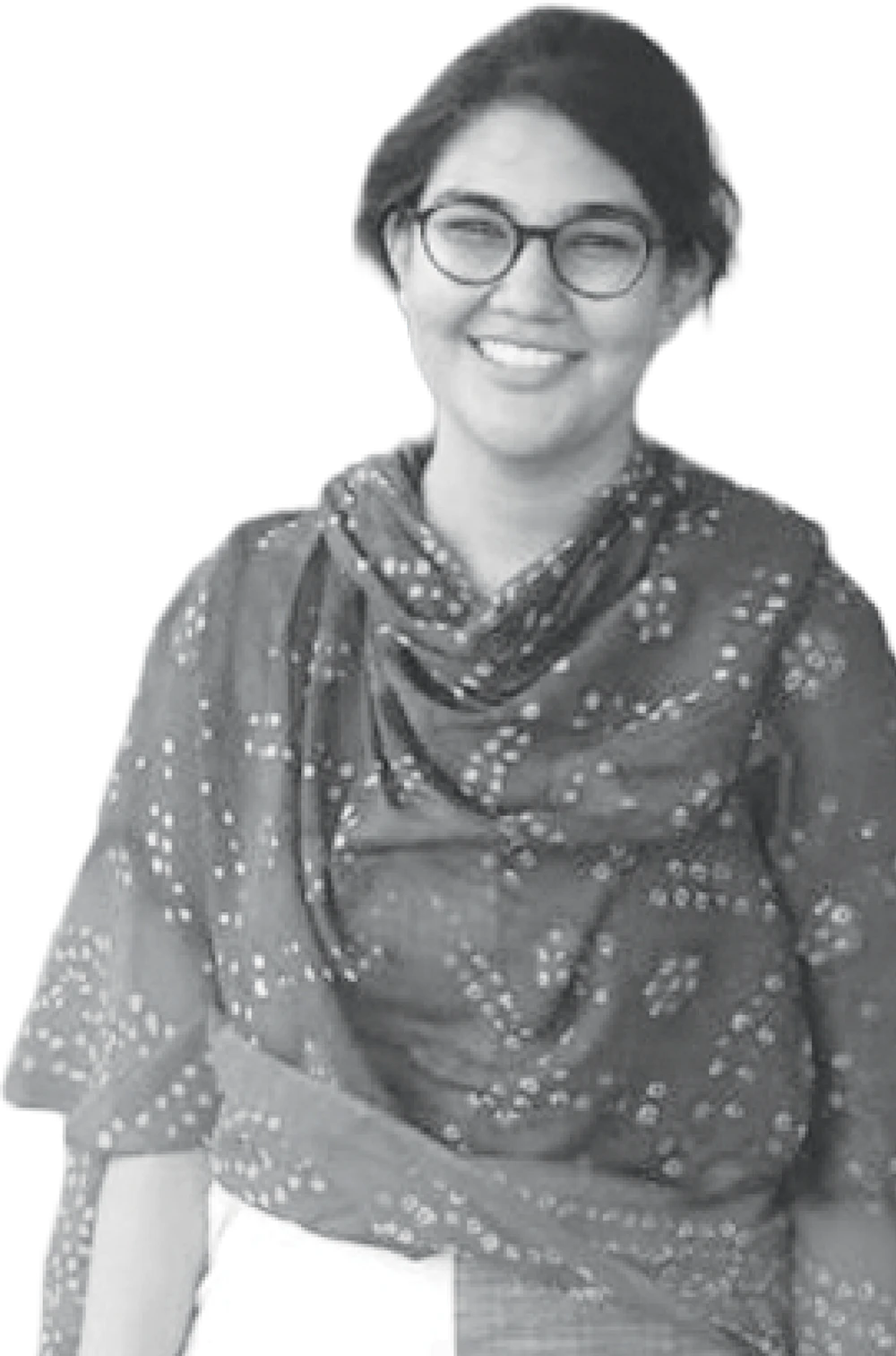Black-and-white portrait of a smiling Ankita Dhussa with glasses wearing a patterned dupatta scarf.