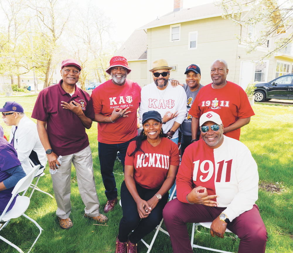 Group of Kappa Alpha Psi fraternity alumni posing together in red and white fraternity apparel.